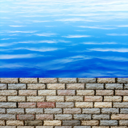 decorative  brick fence wall against blue skyの写真素材