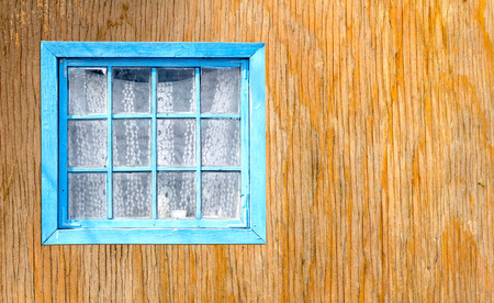 Old window of a wooden house wall