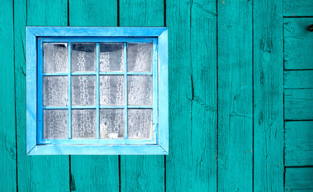 Old window of a wooden house wallの写真素材