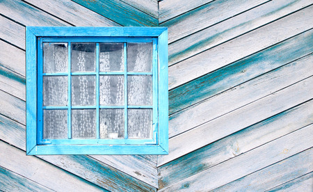 Old window of a wooden house wallの写真素材