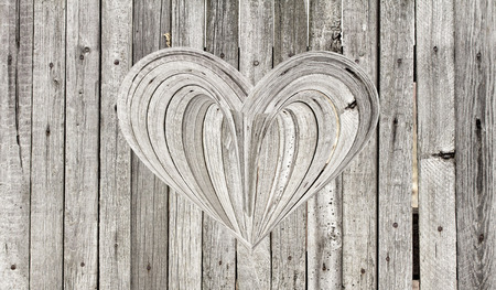 wooden heart on a wooden backgroundの写真素材