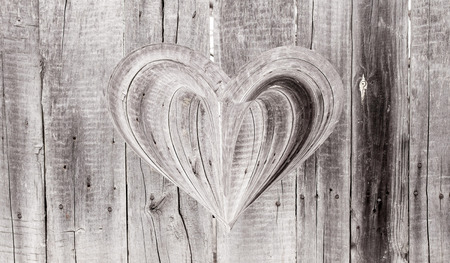 wooden heart on a wooden backgroundの写真素材