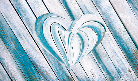 wooden heart on a wooden backgroundの写真素材
