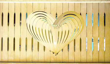 wooden heart on a wooden backgroundの写真素材