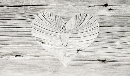 wooden heart on a wooden backgroundの写真素材