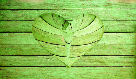 wooden heart on a wooden backgroundの写真素材