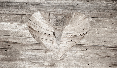 wooden heart on a wooden backgroundの写真素材