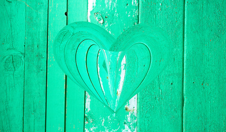 wooden heart on a wooden backgroundの写真素材