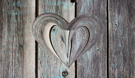 wooden heart on a wooden backgroundの写真素材