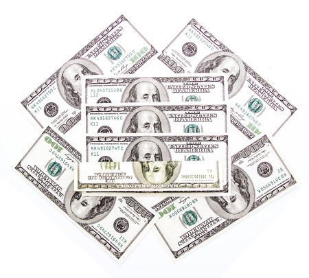 Benjamin Franklin 100 dollar bills arranged randomly with the portrait facing uppermost in a closeup conceptual financial and monetary backgroundの写真素材