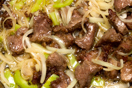 meat fried with onions and peppers, backgroundの写真素材