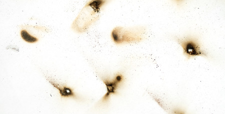 Fire holes in white paperの写真素材