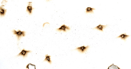 Fire holes in white paperの写真素材