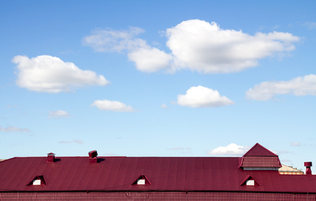red roof against the skyの写真素材