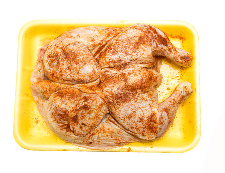 raw chicken in a frying pepperの写真素材