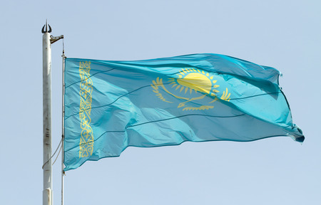 The flag of Kazakhstan against the blue skyの写真素材
