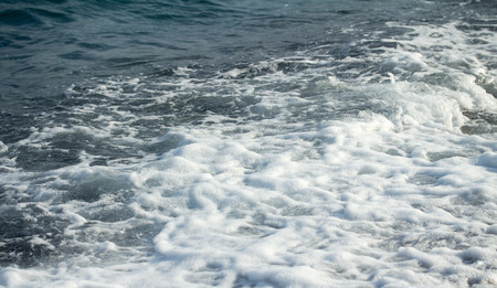 Sea wave foam on the pebble beach.の写真素材