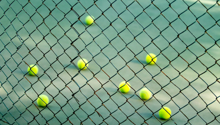 tennis balls over the netの写真素材