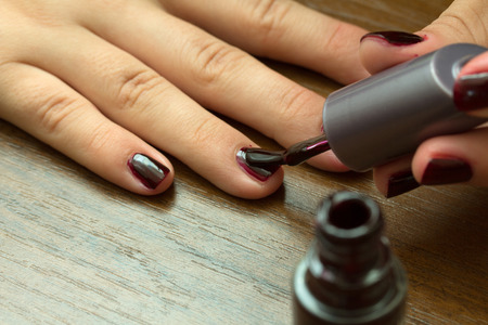 painting fingernails with varnishの写真素材