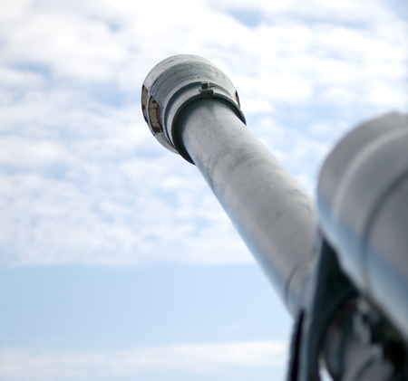 cannon gun from WWII against the skyの写真素材