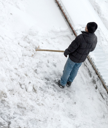 man cleans snow, top viewの写真素材