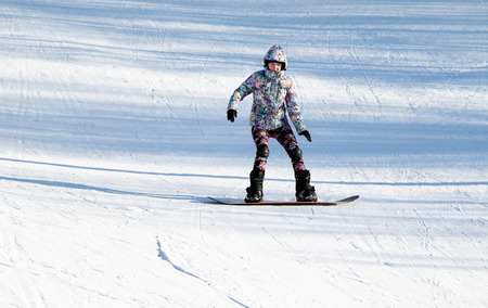 PETROPAVLOVSK, KAZAKHSTAN- JANUARY 24, 2016: Snowboard ride from the mountain in a forest in a recreation center in Kazakhstanのeditorial素材