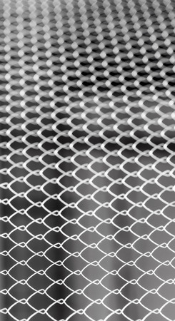 Closeup of wire mesh fence with selective focusの写真素材