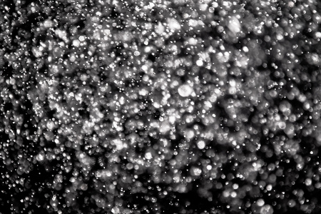 snow bokeh texture on black backgroundの写真素材