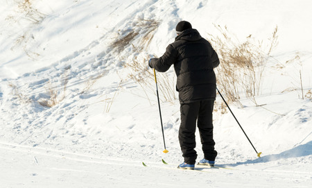 PETROPAVLOVSK, KAZAKHSTAN- JANUARY 31, 2016: Skiers ride from the mountain in a forest in a recreation center in Kazakhstan, a sports vacation.のeditorial素材