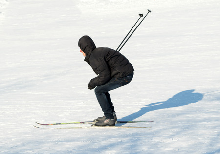 PETROPAVLOVSK, KAZAKHSTAN- JANUARY 31, 2016: Skiers ride from the mountain in a forest in a recreation center in Kazakhstan, a sports vacation.のeditorial素材