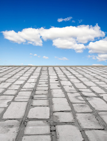 old brick road on the blue sky backgroundの写真素材