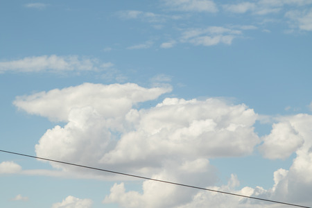 Cloudy cumulus, medium, high in the blue sky background