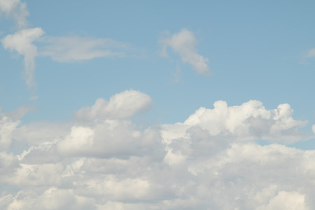Cloudy cumulus, medium, high in the blue sky background