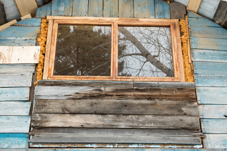 Old windows in wooden housesの写真素材