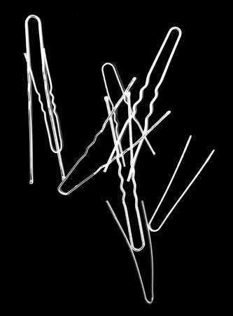 metal hairpins isolated on blackの写真素材