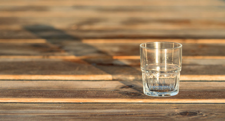 empty glass  standing on the wooden tableの写真素材