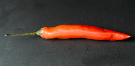 bitter chili pepper on a black backgroundの写真素材