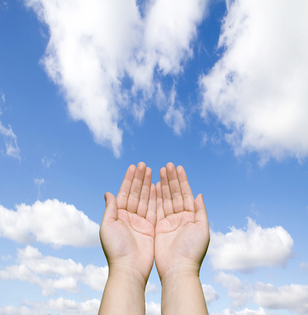 two human hands against the blue skyの写真素材