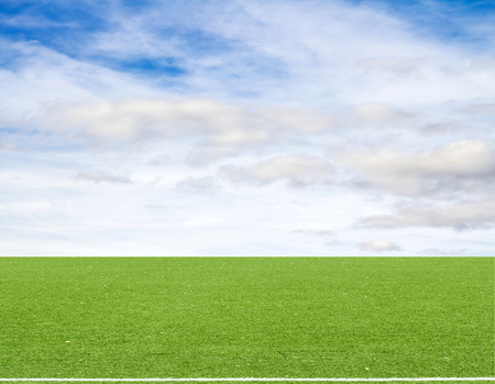 football field blue sky with cloudsの写真素材