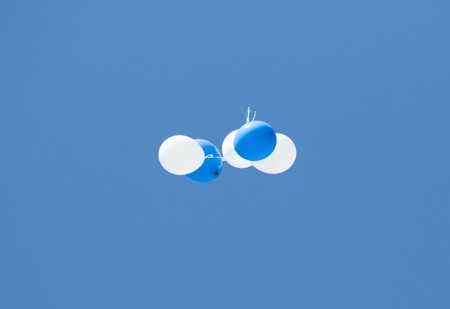 white and blue balloons in the skyの写真素材
