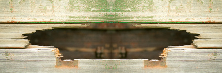 Old wooden background with a holeの写真素材