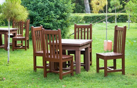 wooden table and chairs outdoorsの写真素材