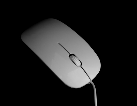 white mouse for the computer on a black backgroundの写真素材