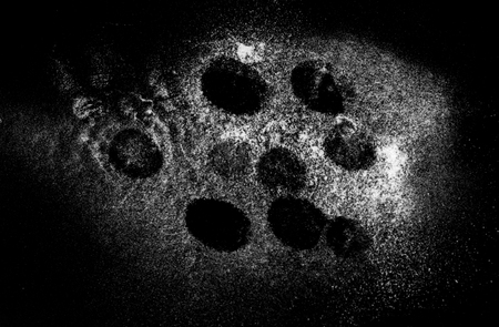 white powder dust on the black backgroundの写真素材