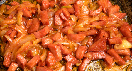 slices of grilled sausage with onionsの写真素材