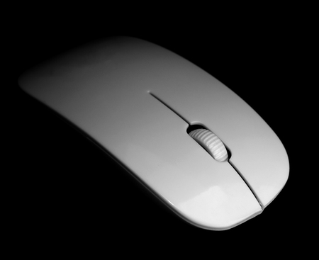 white mouse for the computer on a black backgroundの写真素材