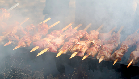 Marinated shashlik preparing on a barbecue grill over charcoal.の写真素材