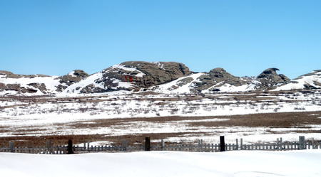 Snow spring steppe hillsの写真素材