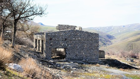 Abandoned stone damaged old house in a mountainous areaの写真素材