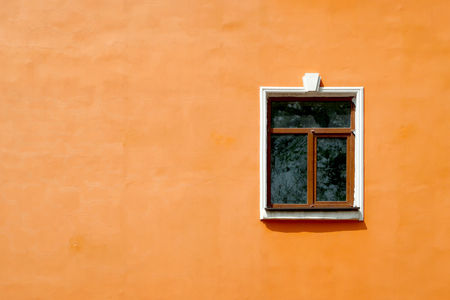 One window against the orange wall background